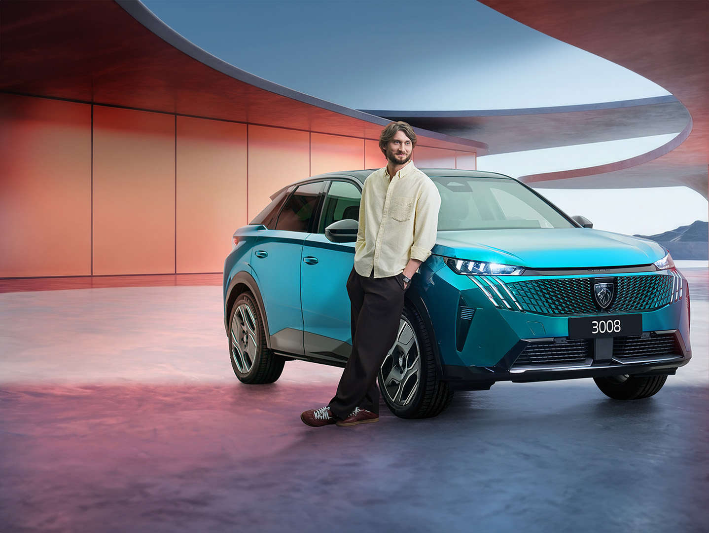 Художній керівник хору «Гомін» біля кросовера Peugeot 3008 синього кольору, вигляд спереду з правого боку